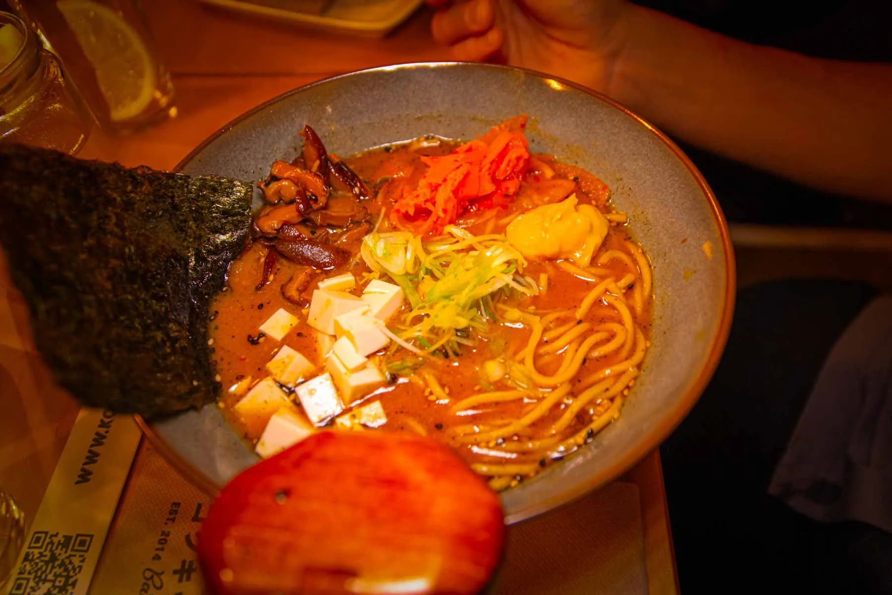 A bowl of ramen with nori on the table at Koku Kitchen Sant Antoni